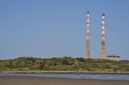 Beautiful closeup bright view of iconic Poolbeg CCGT station chimneys against clear blue sky seen from Sandymount Beach, Dublin, Ireland. Soft colors. Copy spaceのeditorial素材