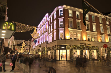 Dublin, Ireland - November 13, 2021: Beautiful evening wide angle view of Brown Thomas hotel decorated with Christmas lights on Grafton Street. Crowded street during COVID pandemic and Christmasのeditorial素材
