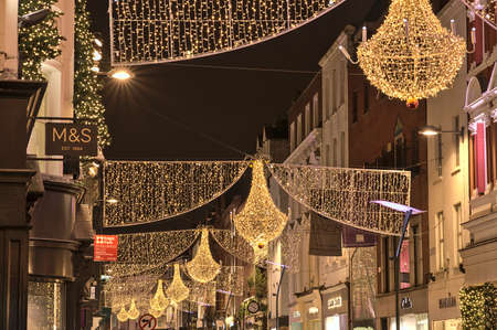 Dublin, Ireland - November 13. 2021: Beautiful closeup evening view of Christmas lights decorations on Grafton Street. Crowded street during COVID pandemic. Irish Christmasのeditorial素材