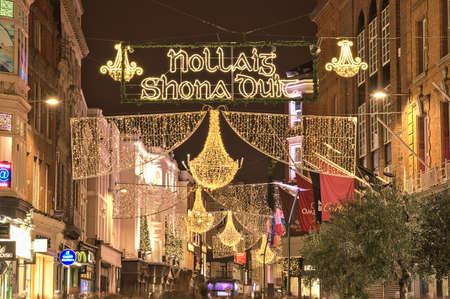 Dublin, Ireland - November 13. 2021: Beautiful evening view of Nollaig shona dhuit Christmas lights. Merry Christmas signboard written in Irish (Gaelic) language on Grafton Street. Crowded streetのeditorial素材
