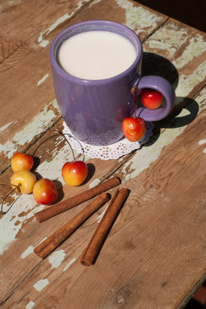 Oatmeal porridge with blueberries and wooden spoon on a blue towelの写真素材