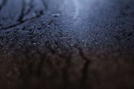 Drops flow down the wall of granite at sunset