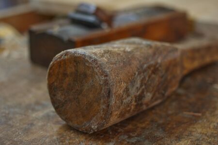 plane and mallet on the workbench in workshopの写真素材