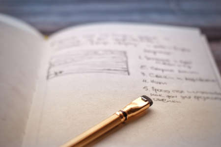 Sketchbook and pencil on a tableの写真素材