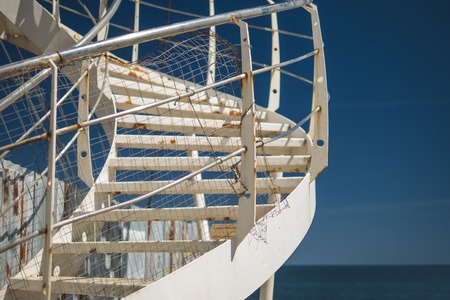 a white spiral staircase by the sea. blue sky on the background.の写真素材