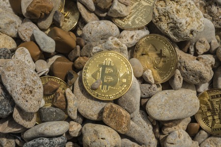 bitcoin Cryptocurrency. e-currency. sea. summer beach. sea stones. sea pebblesの写真素材