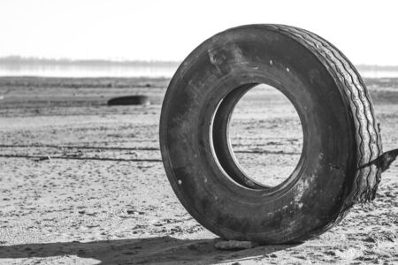 post-apocalyptic landscape. wheel from a truck on the beachの写真素材