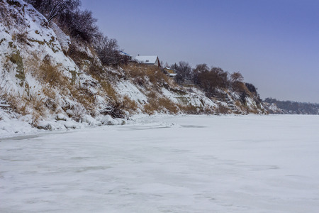 snow-covered cliff on the Bank of the Volga winter riverの写真素材