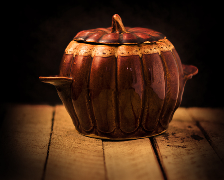 a small pot in the form of pumpkin on the tableの写真素材
