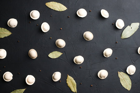 Dumplings on a black background, texture of dumplings, Russian national cuisine