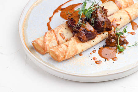 Pancakes with meat, pancakes with beef on a white background, Russian cuisine.の写真素材