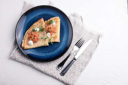 Pancakes with red fish, pancakes with fish on a white background, Russian cuisine.の写真素材