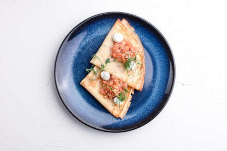 Pancakes with red fish, pancakes with fish on a white background, Russian cuisine.の写真素材