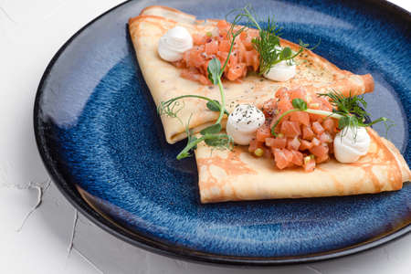 Pancakes with red fish, pancakes with fish on a white background, Russian cuisine.の写真素材