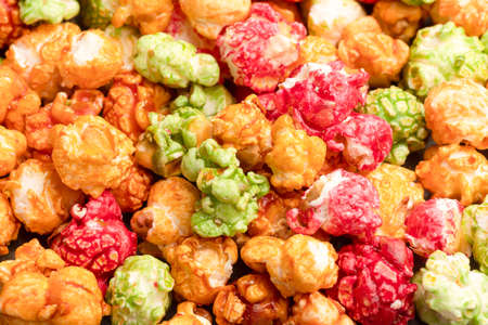 Brightly colored candied popcorn, white background, colored popcorn, colored background.の写真素材