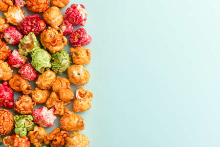Brightly colored candied popcorn, white background, colored popcorn, colored background.の写真素材