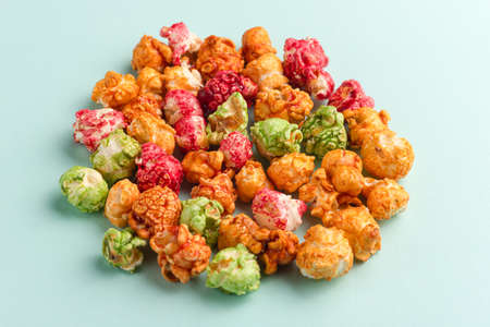 Brightly colored candied popcorn, white background, colored popcorn, colored background.の写真素材