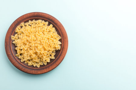 Raw pasta farfalle, Italian pasta, Italian cuisine.