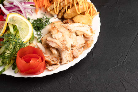 Shawarma on a plate, a large portion of shawarma on a plate, side view, black backgroundの写真素材