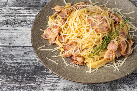 Pasta, carbonara, belenese, with chicken on a white wooden backgroundの写真素材