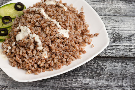 Buckwheat, boiled buckwheat on a wooden white backgroundの写真素材