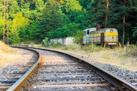 Railway and an abandoned diesel soviet locomotive next to it
