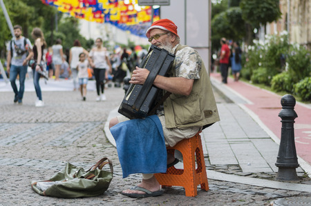 An old man in glasses and a red hat plays in the street on an accordion during the day of the city of Batumi.
Photo Taken on 02.09.2017, Batumi, Georgia.のeditorial素材