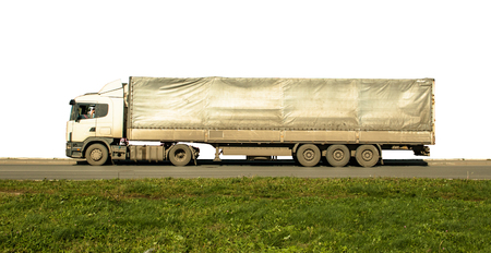 long dirty van truck asphalt road green grass white isolatedの写真素材