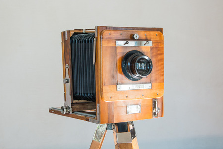 Old vintage big studio camera of wood and metal on white background close upの写真素材
