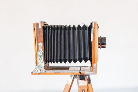 Old vintage big camera of wood and metal on white background close-up side viewの写真素材