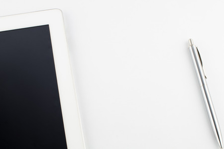 Tablet computer and a modern metal pen on a white background. copy spaceの写真素材