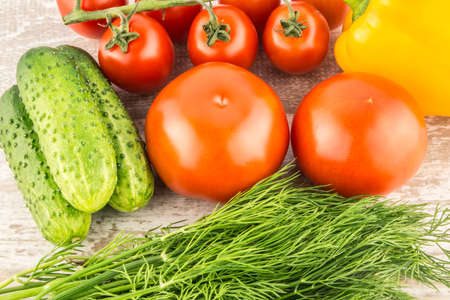 Cucumber, Cherry tomatoes, yellow bell pepper and dill. Vegetarian healthy food.の写真素材
