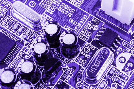 Chip on motherboard mainboard with controllers, ports and wires, close-up macro toned.