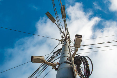 fixed video surveillance camera on a pole in the city.