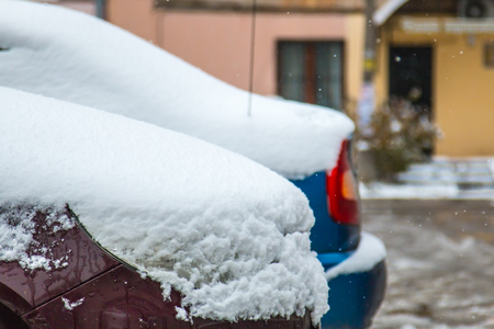 The first snow on cars in the city in the autumn day.の写真素材