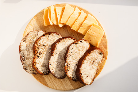 Butter and bread for breakfast, with parsley over rustic wooden backgroundの写真素材