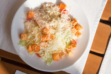 Caesar salad in a street cafe in the sunの写真素材