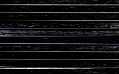 texture of a wooden black wall with relief surfaceの写真素材