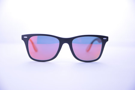 Black-rimmed sunglasses with rainbow glasses on a white background isolated.