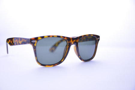 Leopard-rimmed sunglasses with dark glasses on a white background, isolated.