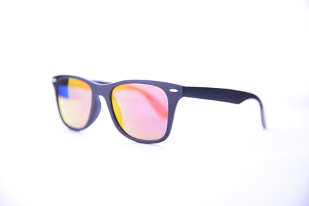 Black-rimmed sunglasses with rainbow glasses on a white background isolated.の写真素材