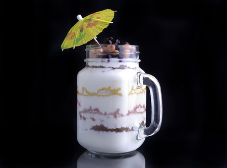 Dessert on a black background with an umbrella.の写真素材