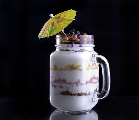 Dessert on a black background with an umbrella.の写真素材
