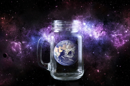 planet earth in a bottle in space background.の写真素材