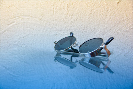 metal glasses on glass on a blue-orange background.