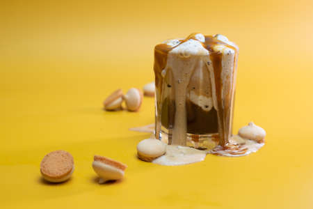 coffee drink with delicate jam and flowing foam on a yellow backgroundの写真素材
