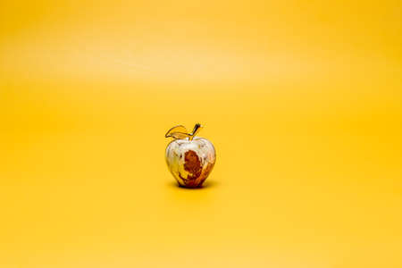 onyx stone apple on yellow background feng shuiの写真素材