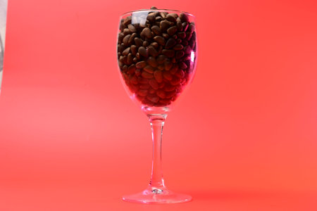 pine nuts in a transparent glass on a red backgroundの写真素材