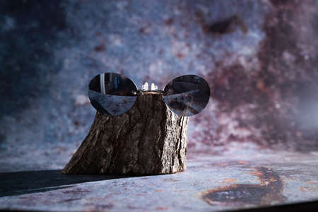 sunglasses on a wooden base on a blue backgroundの写真素材