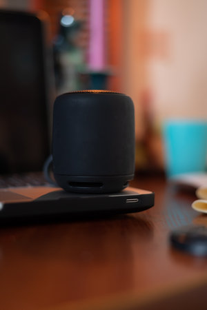 smart speaker on a wooden stand on a light backgroundの写真素材